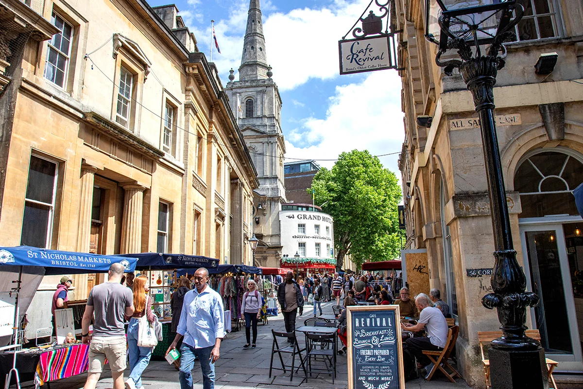 St Nicholas Market traders small stalls with people walking around on street