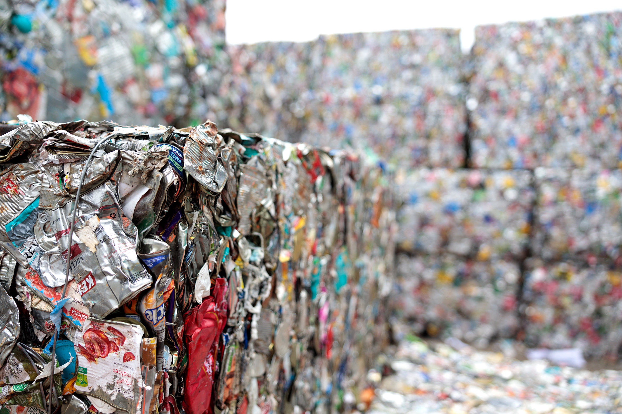 recycling centre showing crushed up cans and plastics