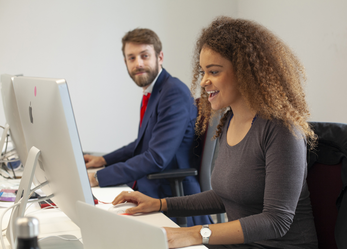 Claire and James - working at computers in an office