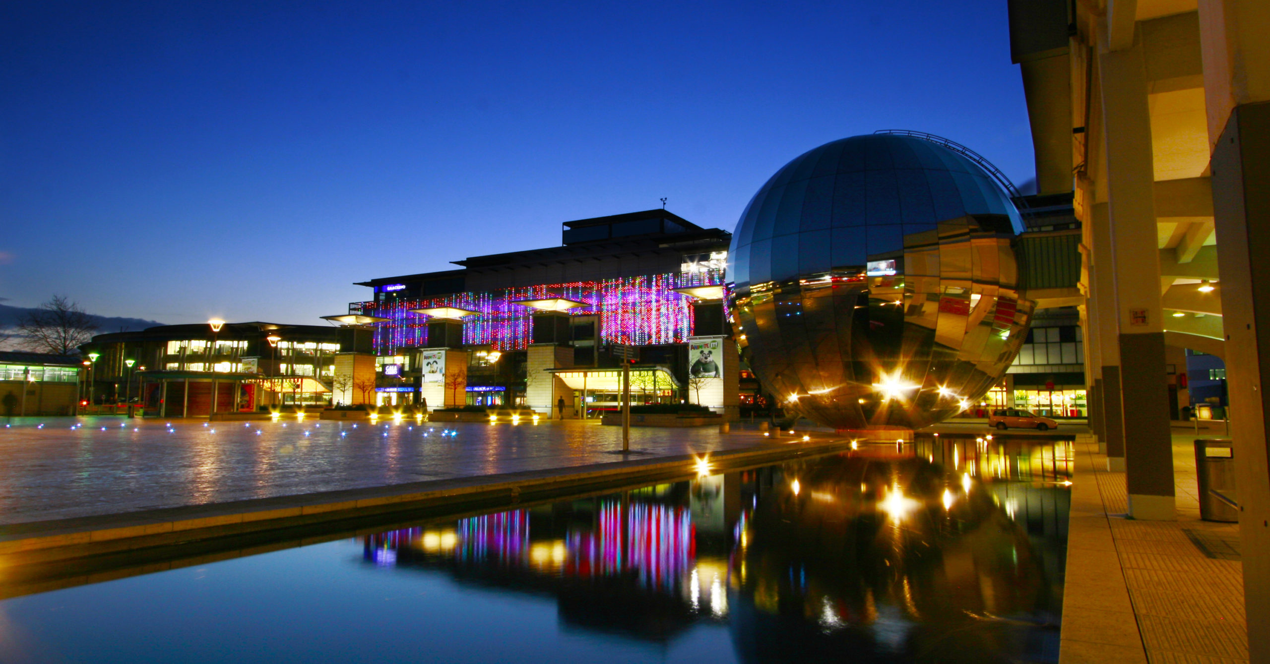 Millennium square at night showing reflections of the water