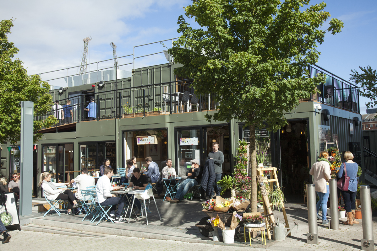 Wapping Wharf cafes & bars with people sitting outside on seats eating and drinking