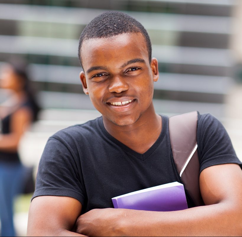 Happy male african university student outdoors